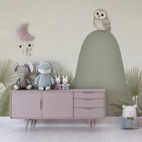 Baby room featuring owl on hill mural wallpaper with soft green and beige colors