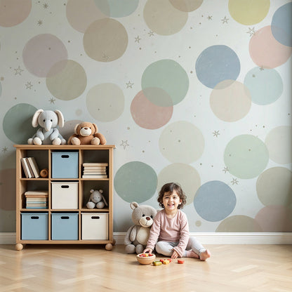 Kids-Mundo pastel circles and stars wall mural styled behind a cot in a soft, neutral nursery