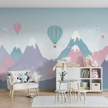 Kids-Mundo pastel mountain mural filling a playroom wall behind soft toy storage