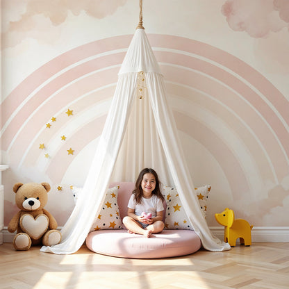 Kids-Mundo pastel rainbow wall mural behind a cot in a soft blush pink nursery.