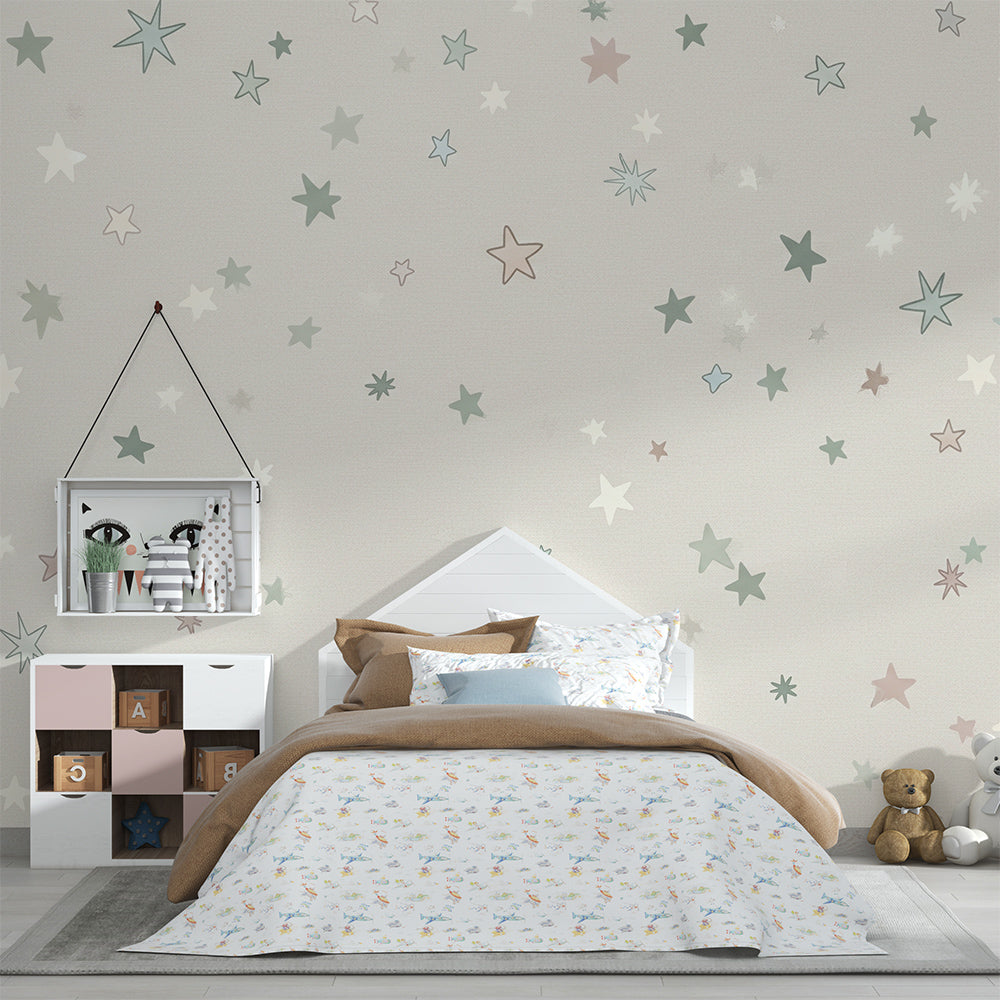 Kids-Mundo pastel stars wall mural on a feature wall above a cot in a soft kids bedroom