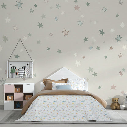 Kids-Mundo pastel stars wall mural on a feature wall above a cot in a soft kids bedroom