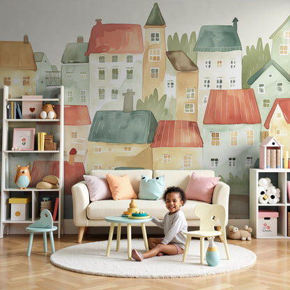 Kids-Mundo pastel village wall mural with colourful rooftops behind a cot in a nursery