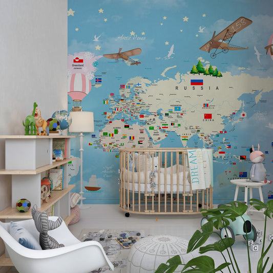 Kids-Mundo world map wall mural on a kids' bedroom wall, striped balloons and vintage biplanes in soft pastel tones.