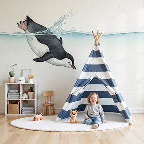 Swimming penguin mural wallpaper creating serene ocean theme in modern baby nursery by Kids-Mundo