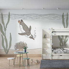 Marine life mural wallpaper with penguin and starfish creating aquatic playroom atmosphere