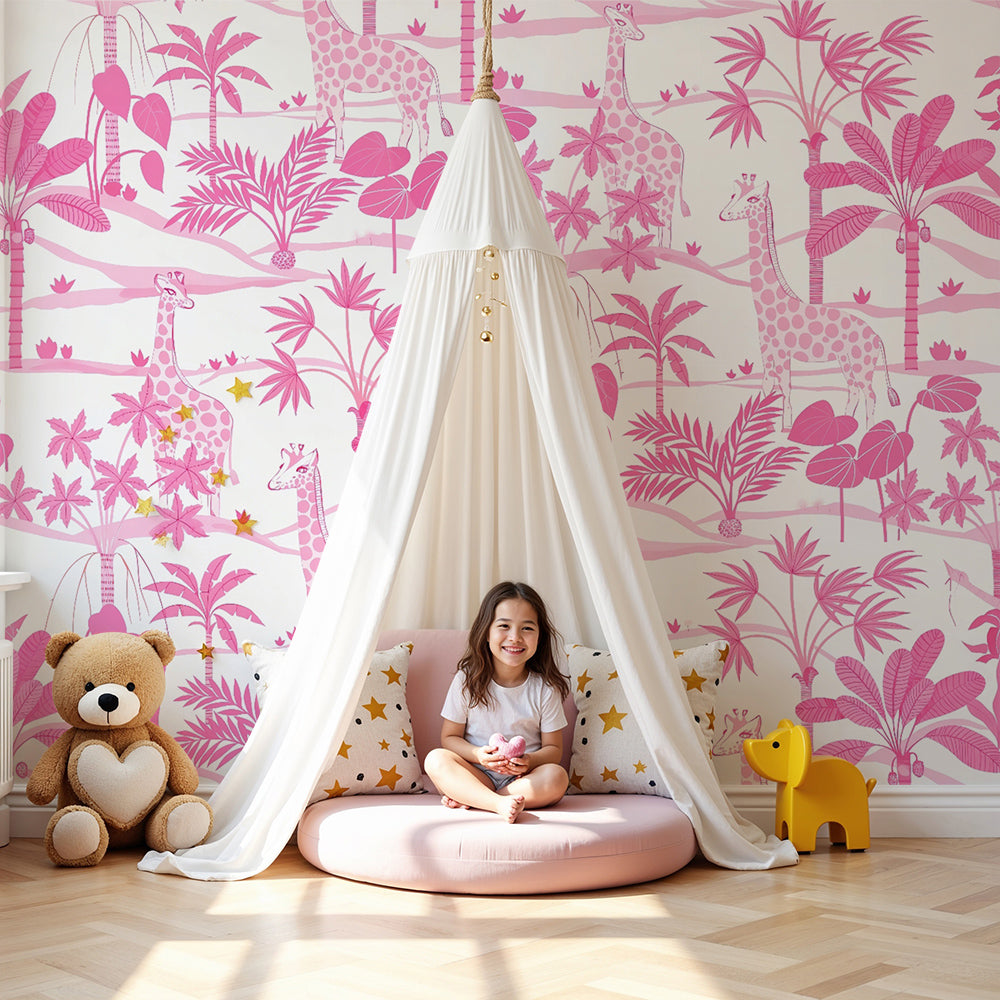 Kids-Mundo pink giraffe jungle wall mural in a bright nursery with a cot and soft furnishings
