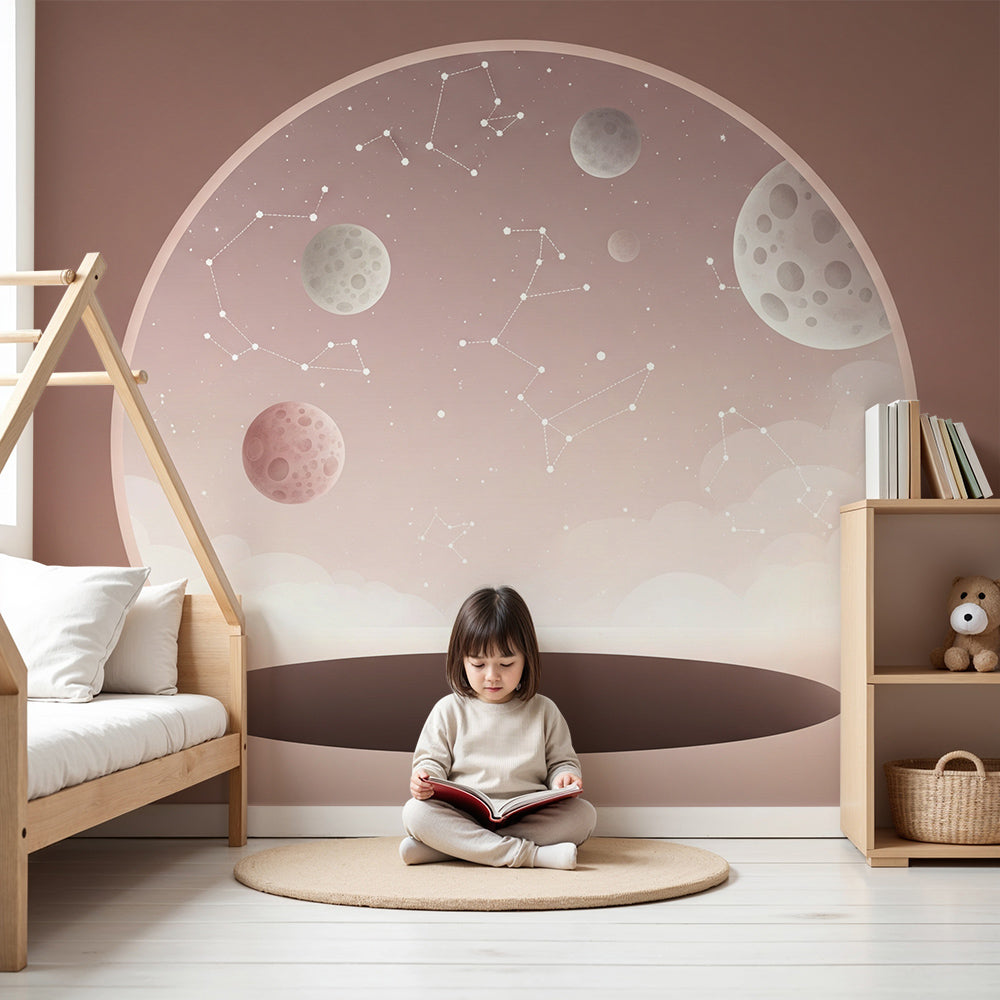 Kids-Mundo blush pink space wall mural with moons and stars styled in a soft pastel nursery