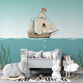 Ocean pirate ship wallpaper creating adventurous nursery atmosphere with turquoise waters