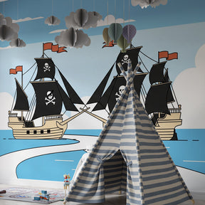 Children's pirate themed mural wallpaper with sailing ships in bright playroom setting