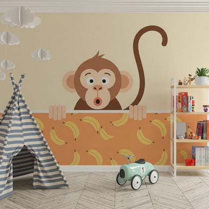 Kids-Mundo banana print monkey wall mural behind a bed in a bright kids bedroom.