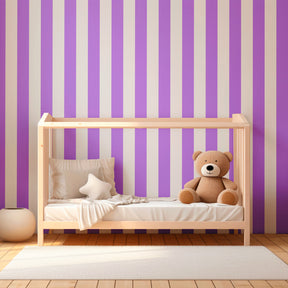 Purple striped wallpaper complementing light wood furniture in child's room