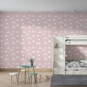 Pink rainbow and cloud wallpaper creating dreamy atmosphere in children's bedroom