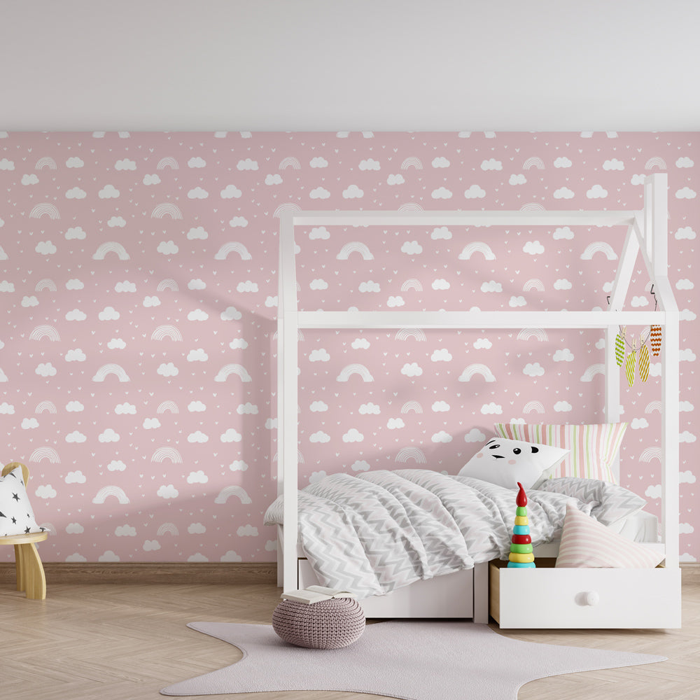 Whimsical cloud and rainbow mural wallpaper decorating bright kids playroom space