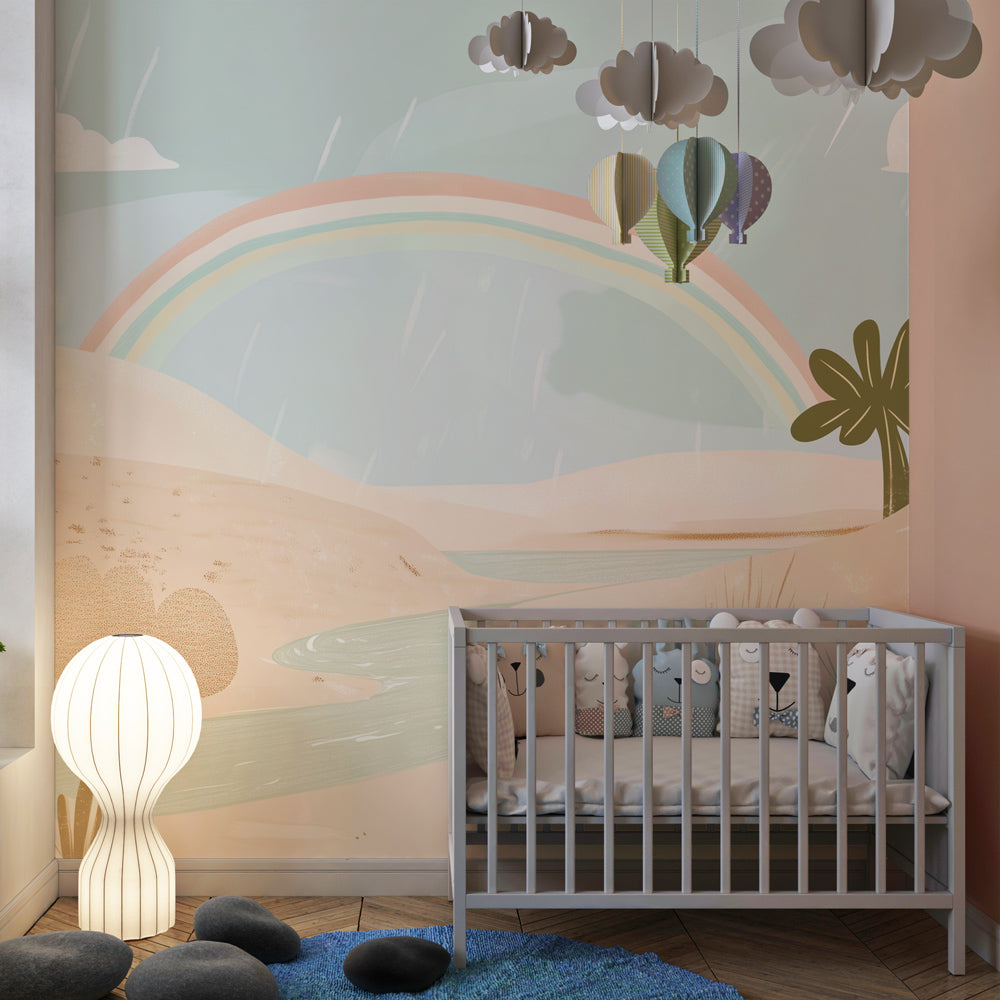 Magical desert rainbow mural wallpaper installed in bright kids playroom setting