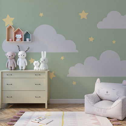 Kids-Mundo sage green clouds wall mural behind a bed in a soft, modern kids bedroom