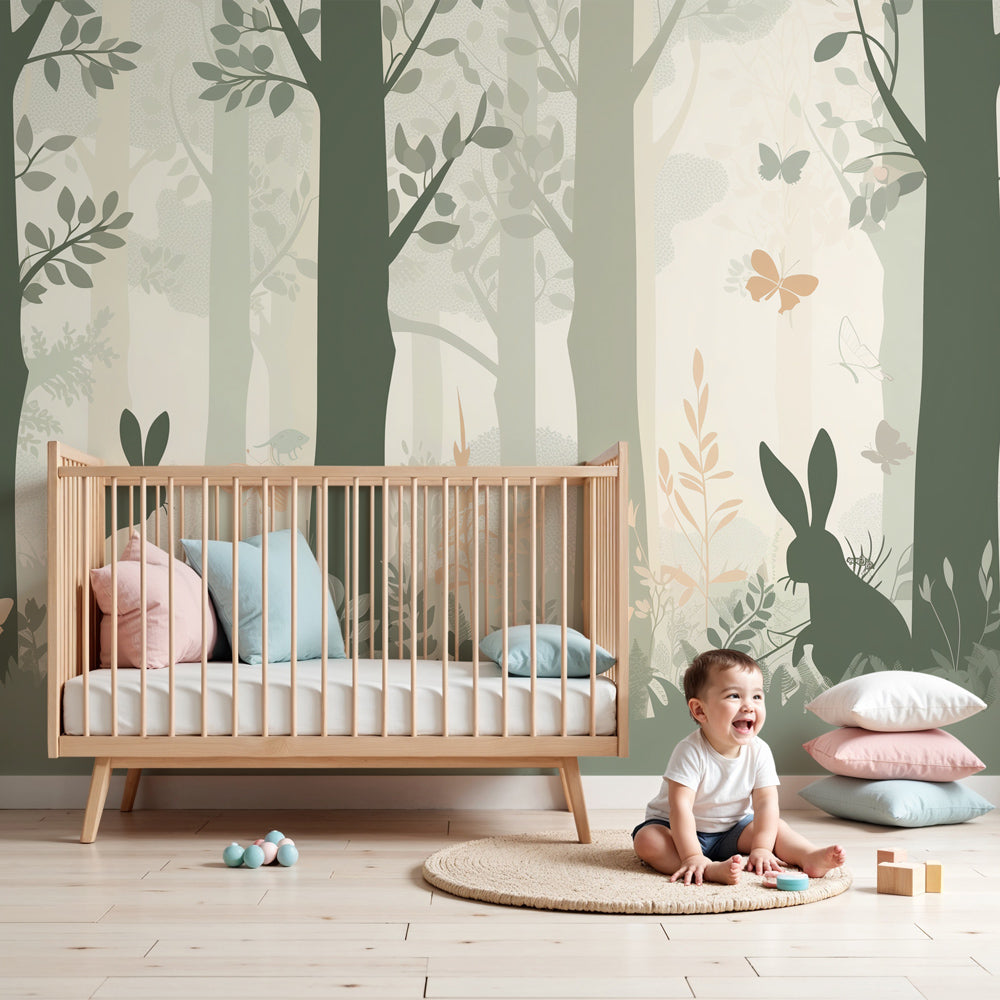 Kids-Mundo sage green forest silhouette wall mural styled behind a cot in a calm nursery.