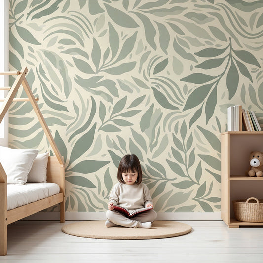 Kids-Mundo sage green leaf wall mural on a feature wall in a bright, calm nursery with a cot
