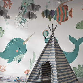 Marine life mural wallpaper with narwhal and jellyfish in kids playroom by Kids-Mundo