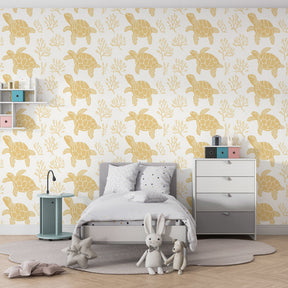 Ocean-themed children's bedroom featuring sea turtle wallpaper with golden accents and coral patterns