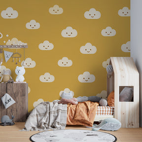 Golden clouds wallpaper creating cheerful atmosphere in children's bedroom with wooden furniture
