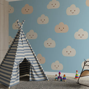 Blue sky clouds wallpaper with happy faces decorating cozy children's bedroom space