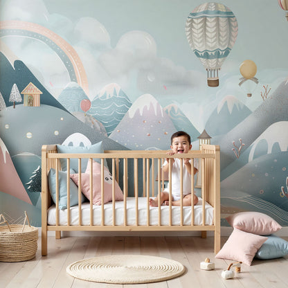 Kids-Mundo snowy village hot air balloon wall mural styled behind a cot in a soft pastel nursery