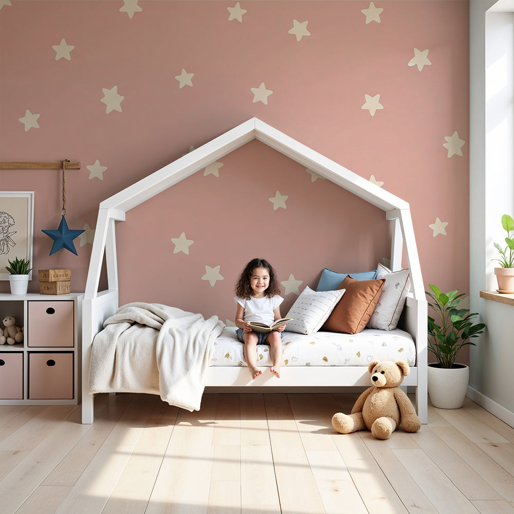 Kids-Mundo soft pink star wall mural styled in a calm baby girl's nursery with a cot nearby.