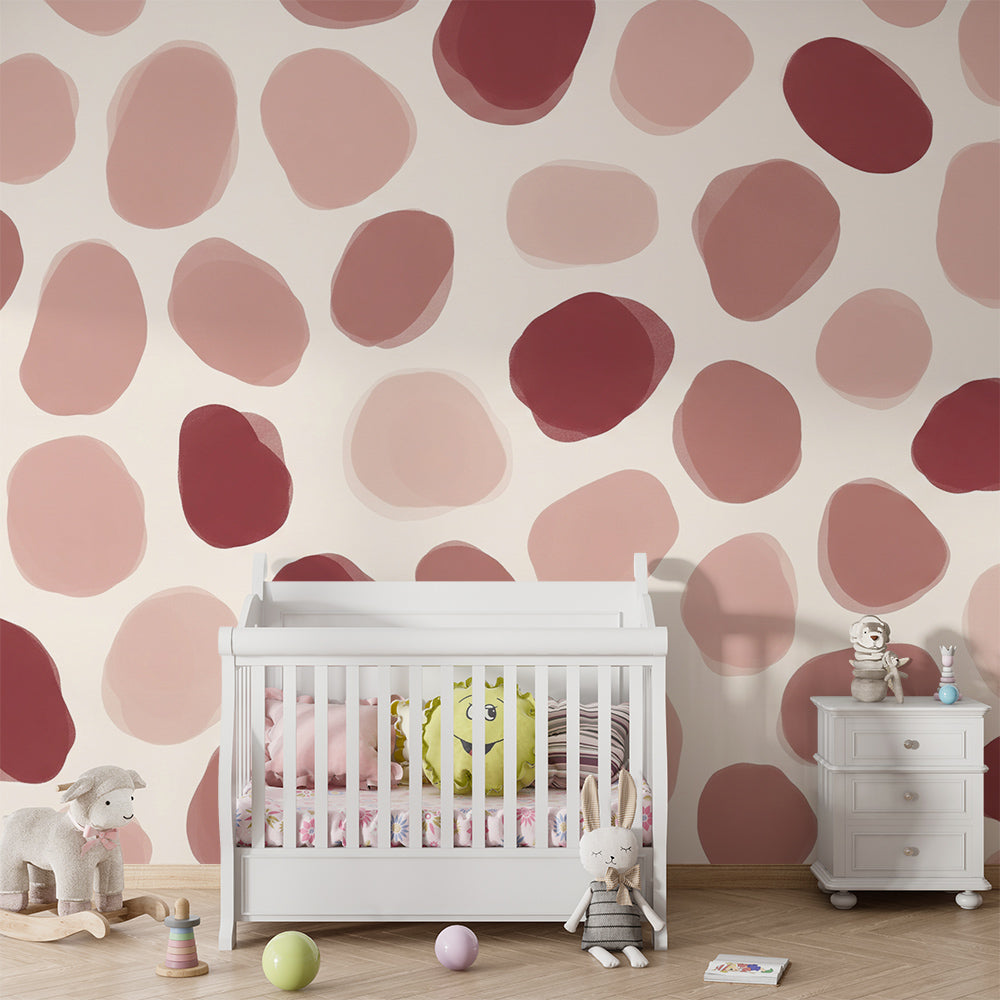 Kids-Mundo pebble shapes wall mural in blush and terracotta tones on a bedroom wall