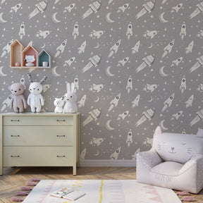 Cosmic rocket wallpaper creating magical space-themed children's bedroom atmosphere