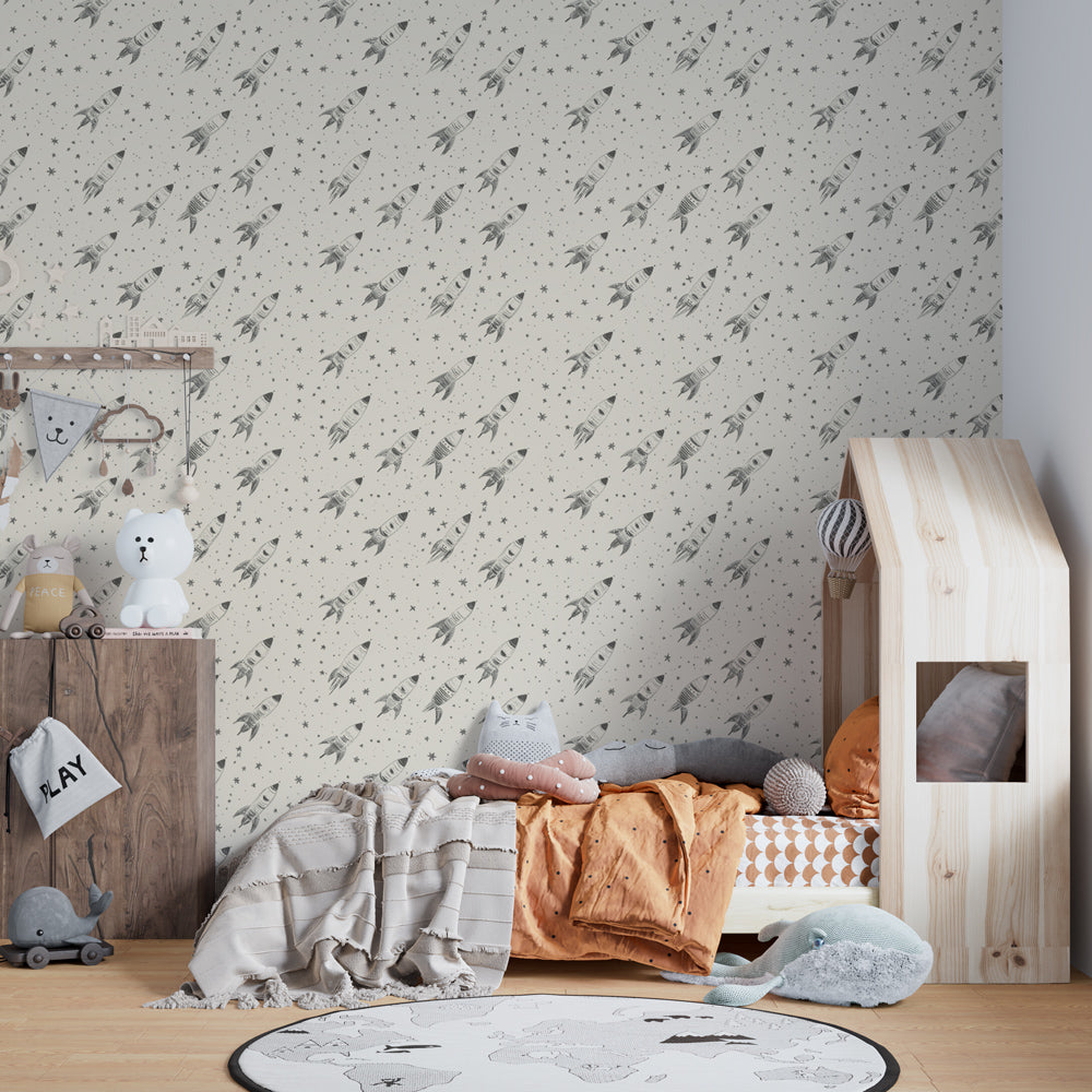Cosmic themed kids bedroom featuring space rocket wallpaper with soothing beige background
