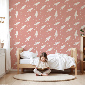 Space rocket mural wallpaper creating magical nursery decor with soft pink tones by Kids-Mundo