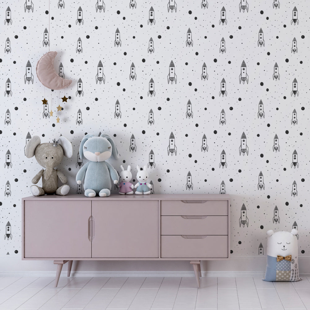 Black and white rocket planet wallpaper inspiring imagination in kids playroom setting