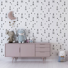 Black and white rocket planet wallpaper inspiring imagination in kids playroom setting