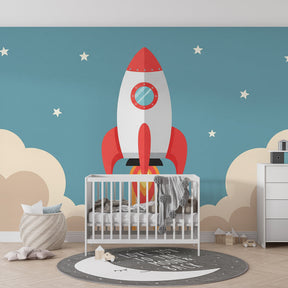 Space adventure mural wallpaper installed in bright kids playroom showing rocket ship and cloud details