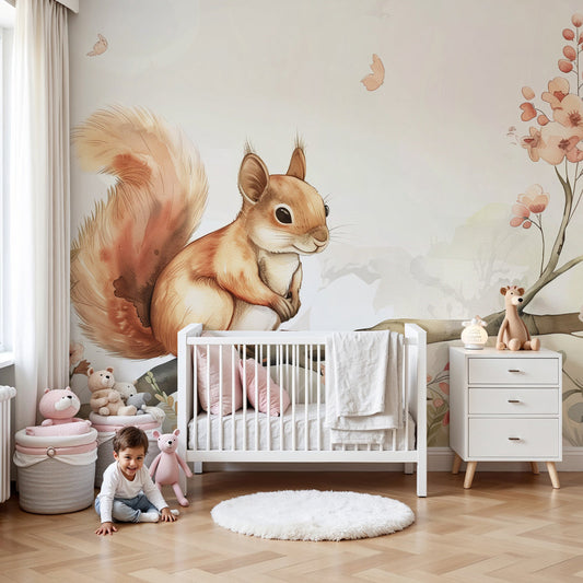 Kids-Mundo squirrel and blossom branch wall mural styled in a soft pastel nursery with a cot
