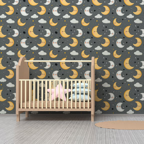 Moon and stars wallpaper creating peaceful nursery atmosphere with wooden furniture