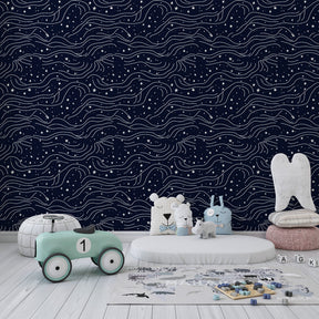 Celestial stars mural wallpaper creating dreamy kids bedroom atmosphere with navy blue tones