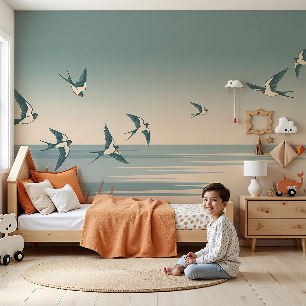 Kids-Mundo swallows wall mural in a calm nursery, made-to-measure dusk shoreline wallpaper behind a cot.