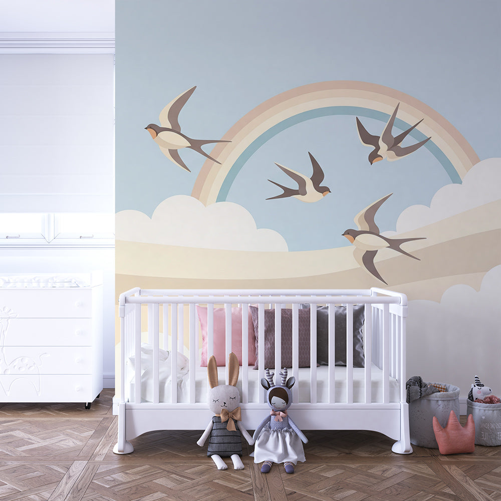 Kids-Mundo swallow and rainbow wall mural brightening a playroom wall with soft, playful movement.