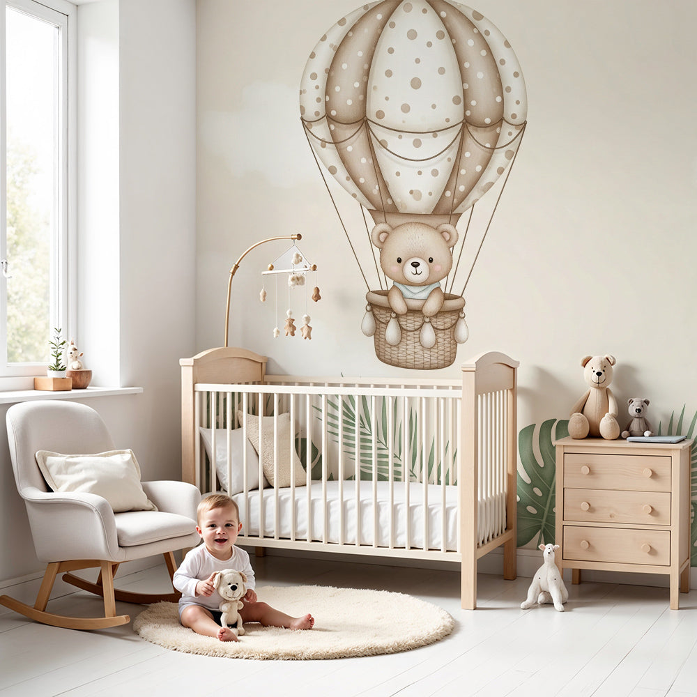 Kids-Mundo teddy bear balloon wall mural above a cot in a calm, neutral nursery