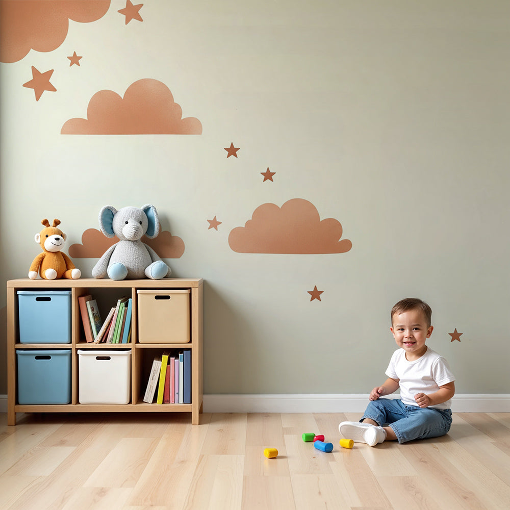 Kids-Mundo terracotta clouds and stars wall mural styled above a cot in a soft nursery