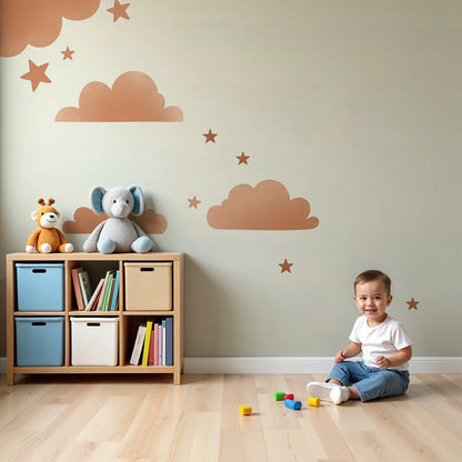 Kids-Mundo terracotta clouds and stars wall mural styled above a cot in a soft nursery