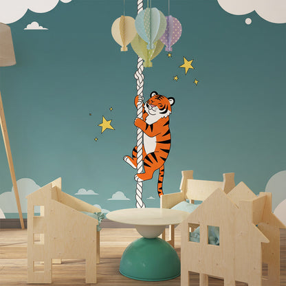 Kids-Mundo climbing tiger mural decorating a playroom wall with soft seating below