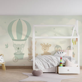 Whimsical animal train mural wallpaper with soft pastel clouds in children's room setting