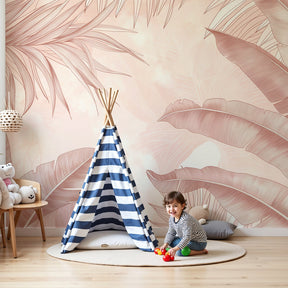 Tropical leaves mural wallpaper in soft pink tones decorating modern nursery room by Kids-Mundo