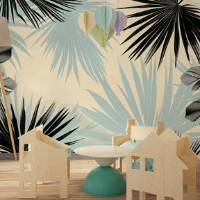 Black and blue palm leaves wallpaper transforming kids playroom into jungle paradise