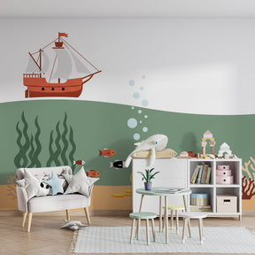 Ocean themed mural wallpaper creating magical underwater nursery with pirate ship and marine life