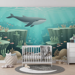 Whale and coral mural wallpaper creating peaceful underwater atmosphere in kids bedroom