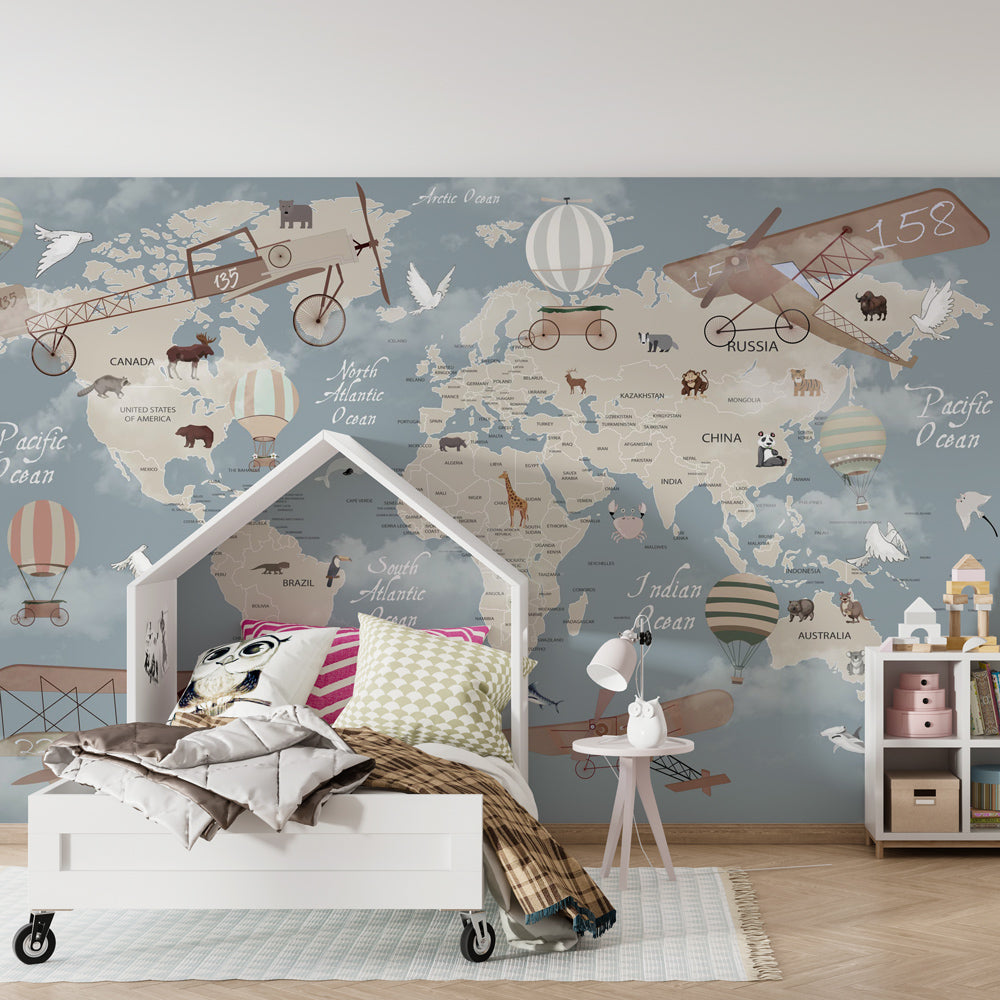 Kids-Mundo world map wall mural on a kids' bedroom wall, vintage biplanes and balloons among wild animals.